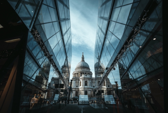 View Of St. Paul's Cathedral Reflected In The Glass Of A Modern Shopping Center Or Mall.